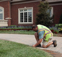 a Woodbridge sprinkler repair contractor is checking a riser